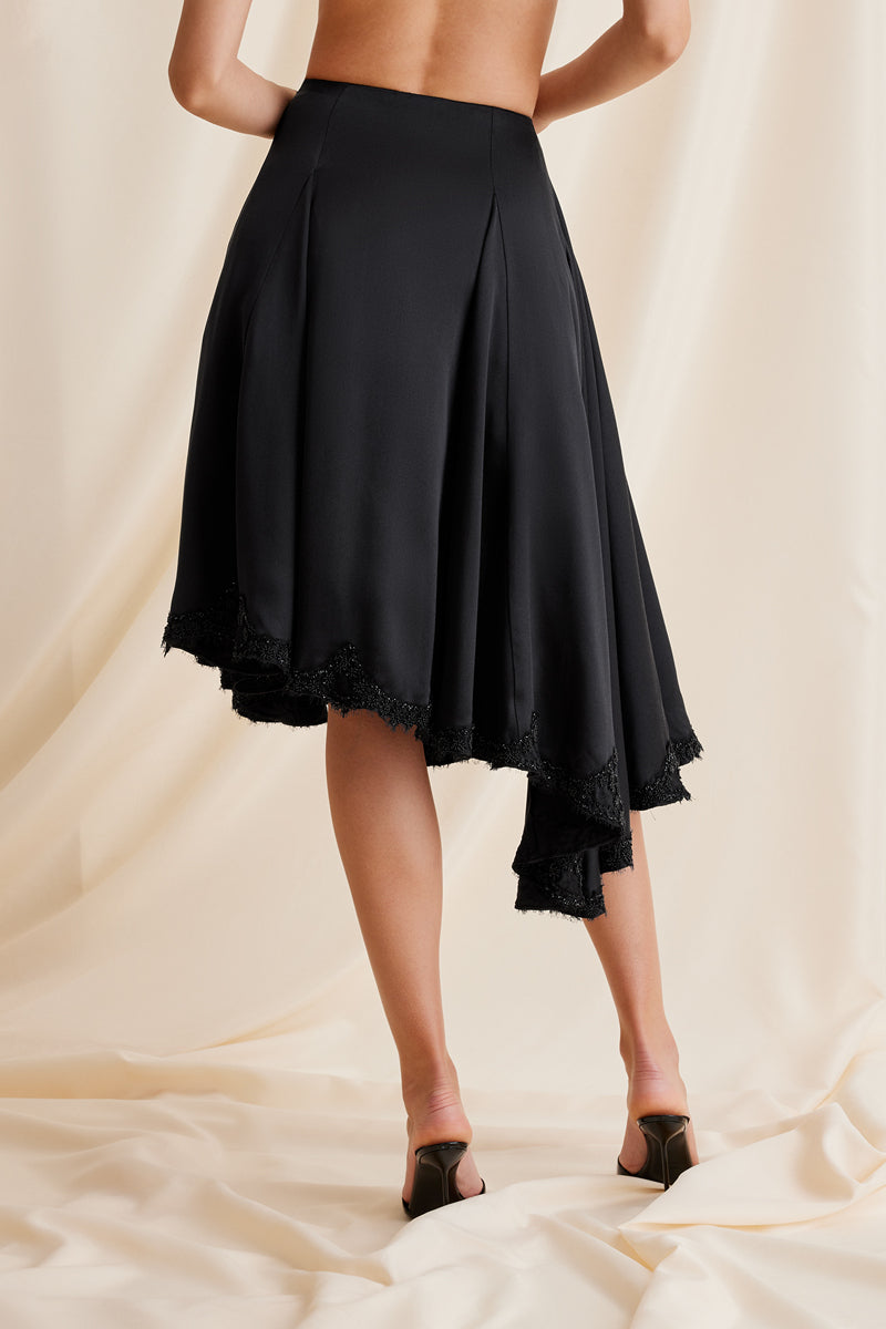 Black Scarlett Gasque Lauren midi skirt displayed from the back, showcasing its sleek design and elegant fit.