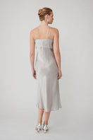 Silver MASTANI slip dress in midi length, featuring smooth fabric and elegant design, displayed on a hanger.