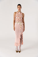 Pink handmade crochet top featuring intricate floral design from Andreeva, displayed on a neutral background.