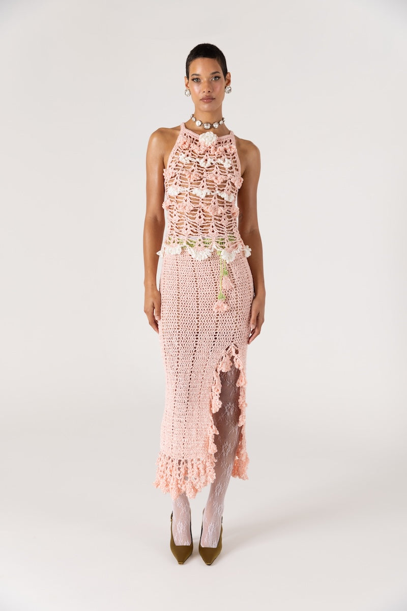 Pink handmade crochet top featuring intricate floral design from Andreeva, displayed on a neutral background.