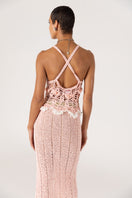 Pink handmade crochet top featuring chrysanthemum design by Andreeva, displayed on a neutral background.