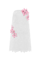 White strapless mini lace dress by Valenciani, showing intricate lace details and a fitted silhouette.