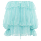 Turquoise off-shoulder mini dress styled as a scarf, by Valenciani, shown in a vibrant, flowing fabric with detailed draping.