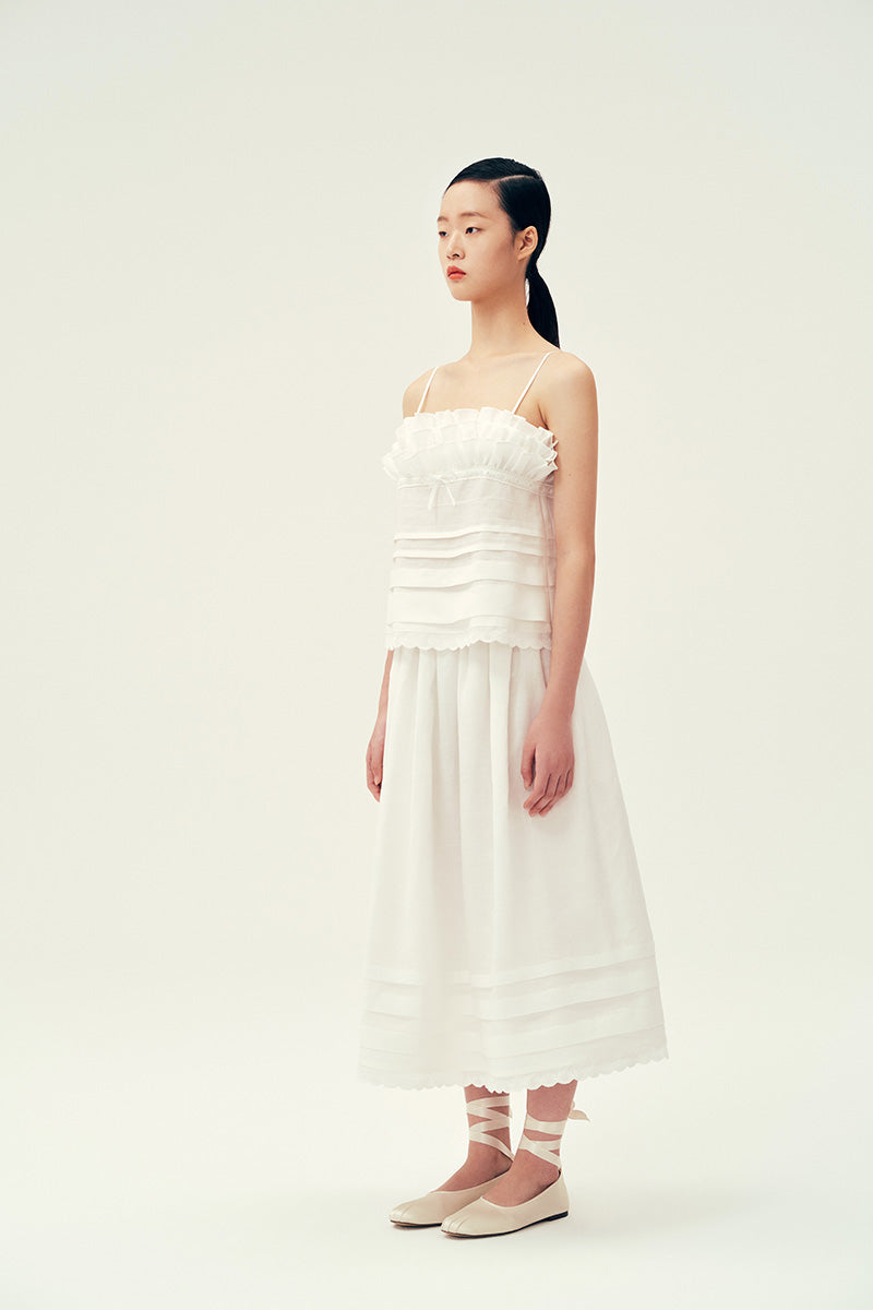 Ivory midi skirt by Chictopia displayed on a hanger, showcasing its flowy fabric and elegant length.