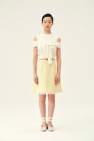 Chictopia Bonnie mini skirt in pastel yellow, lightweight fabric, high waist, and flowy design, perfect for spring and summer outfits.
