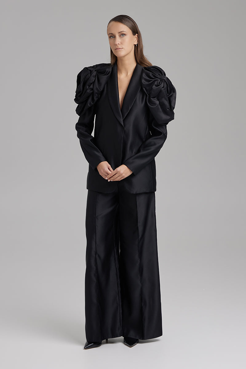 Black blazer from BAÉ's Rose Jet collection, tailored fit with sleek lapels, shown on a model.