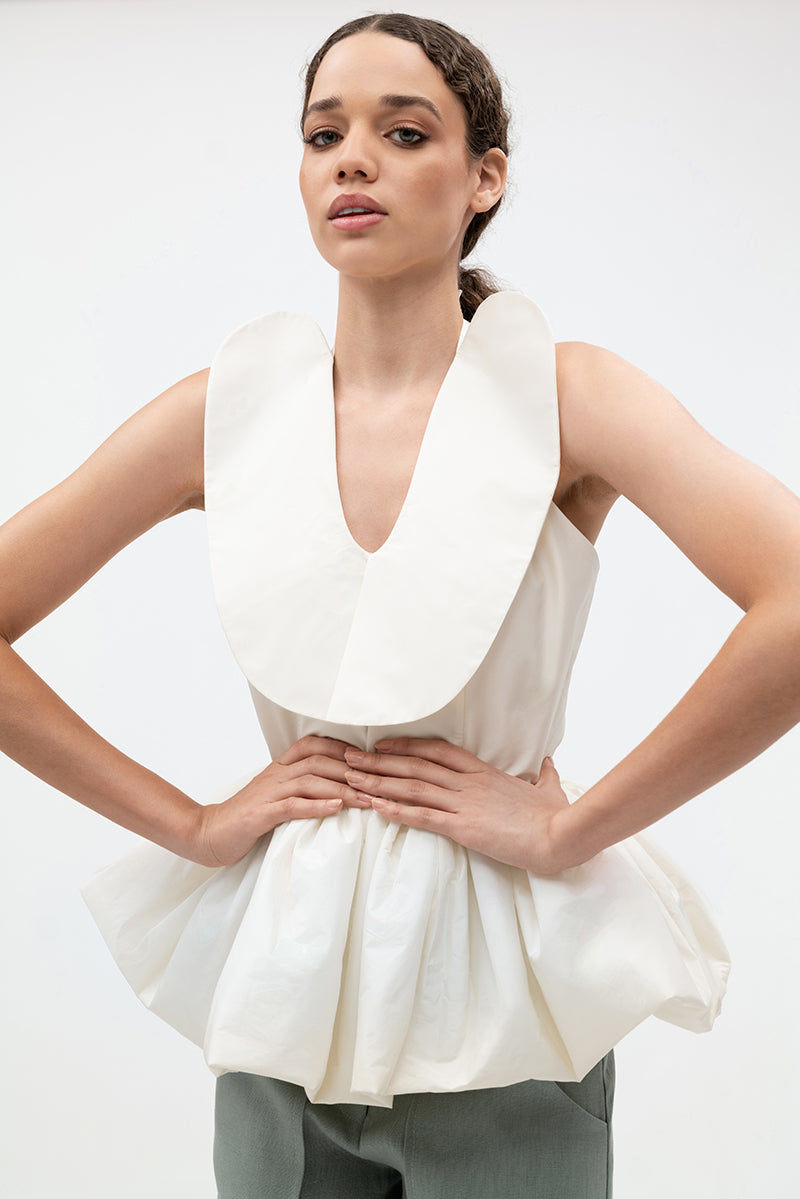 Ivory Corina blouse by Ana + Maria, featuring a stylish and elegant top with detailed fabric and modern design.