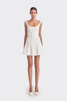 White corset A-line mini dress by Stolen Stores, featuring fitted bodice and flared skirt, perfect for stylish occasions.