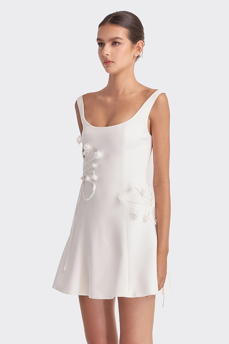 White corset A-line mini dress by Stolen Stores, featuring fitted bodice and flared skirt, perfect for stylish occasions.