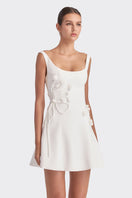 White corset A-line mini dress by Stolen Stores, featuring a fitted bodice and flared skirt, stylishly displayed on a hanger.