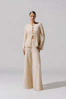 Baobab Corsica Pants in ivory color, casual pants with a relaxed fit and stylish design, shown on a model.