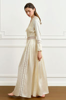 Yellow silk women's robe by MANITO, featuring a smooth, luxurious fabric and elegant design, displayed on a hanger.