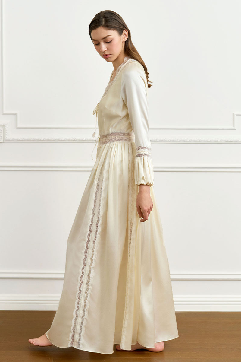 Yellow silk women's robe by MANITO, featuring a smooth, luxurious fabric and elegant design, displayed on a hanger.
