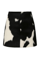 Black and white cowhide mini skirt by ZUT, featuring a sleek, fashionable design with a fitted waist and stylish pattern.