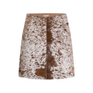 ZUT toffee cowhide mini skirt shown on a model, featuring a stylish, fitted design perfect for casual or dressy outfits.