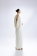 White Valenciani gown with a cowl back and cape sleeve, elegant evening dress with flowing fabric.