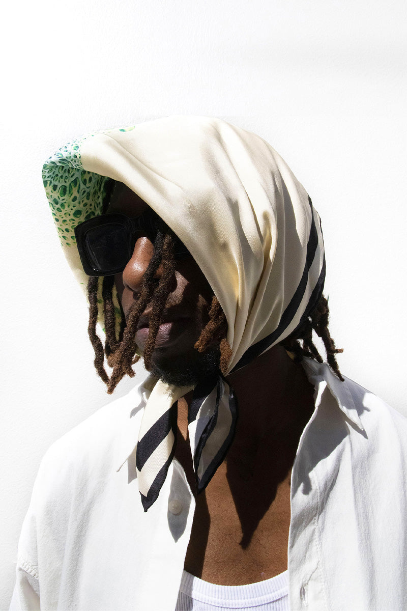 Creamy Moussard silk scarf by Amel Batita featuring a soft, luxurious blue fabric with elegant draping.