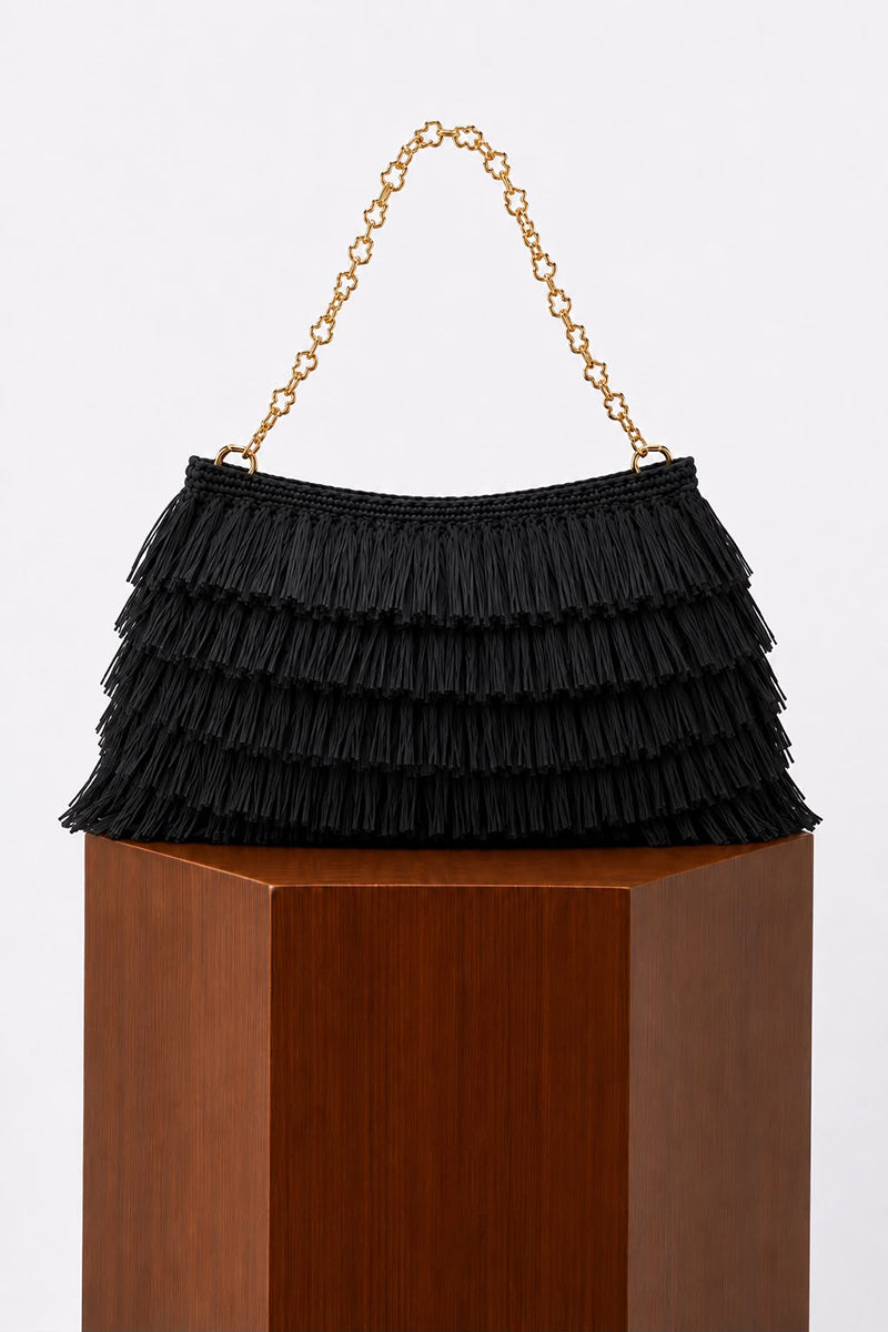 Black crochet raffia clutch bag by Folklore The Label featuring a textured woven design and a compact, stylish silhouette.