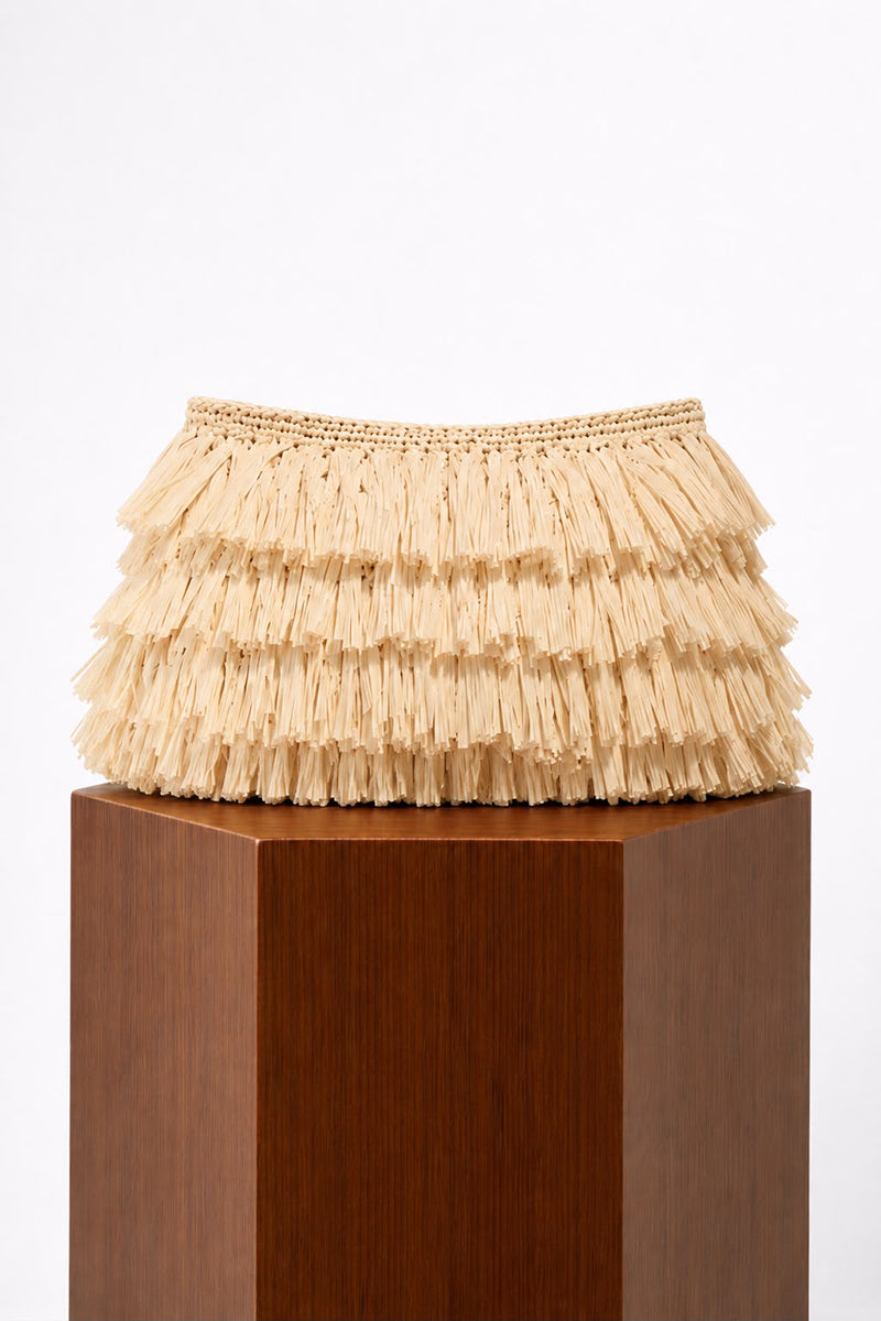 Ivory crochet raffia clutch bag by Folklore The Label, featuring intricate crochet design and compact, stylish shape.
