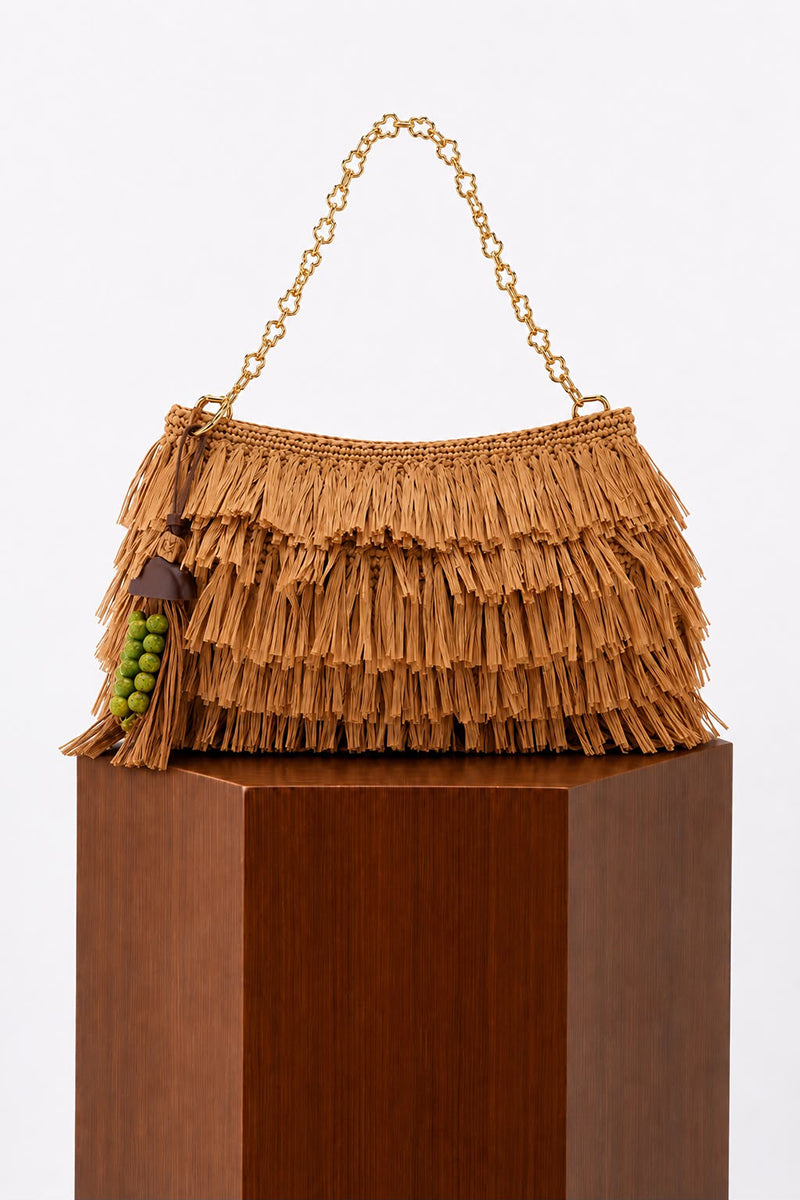 Natural crochet raffia clutch bag by Folklore The Label with woven texture and compact design.