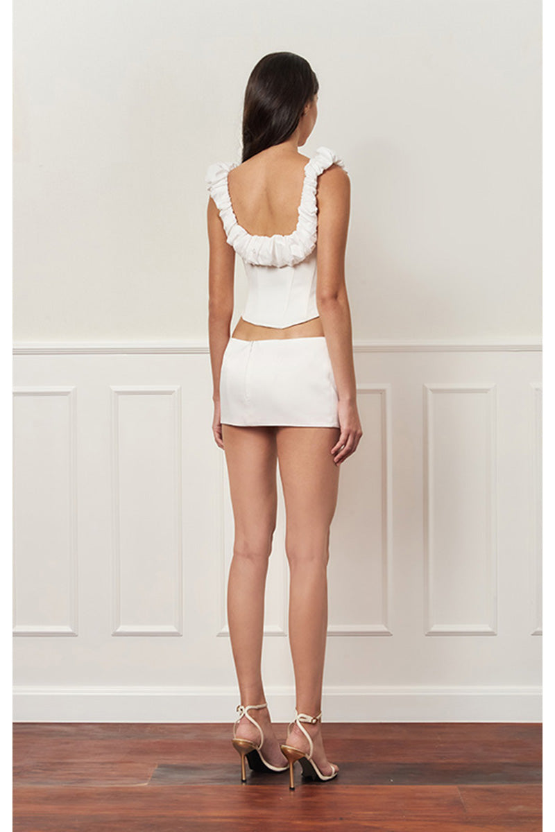 Off-white croissant-shaped bustier corset top by Stolen Stores, with structured design and detailed stitching.