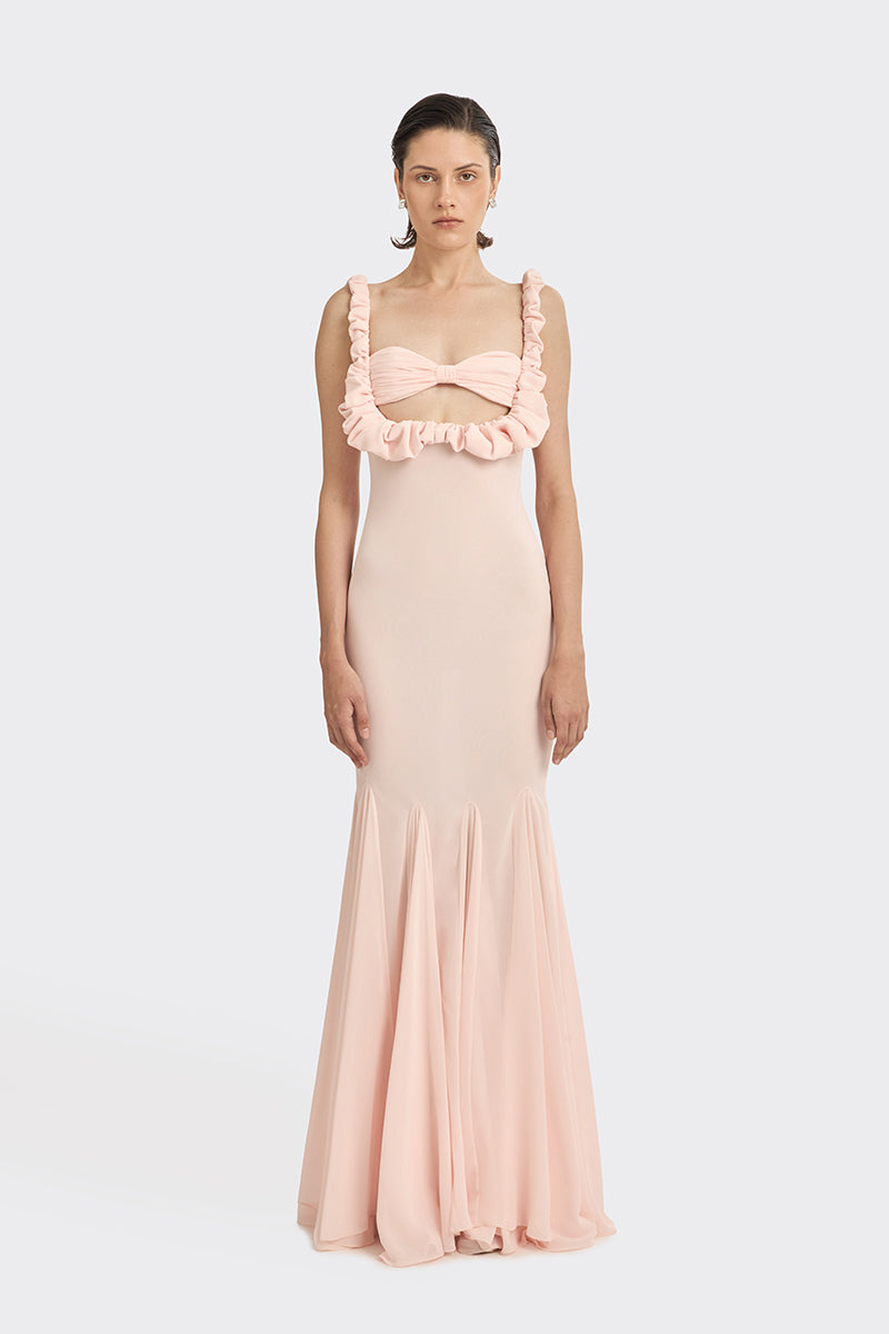Stolen Stores CULT MIA X Croissant light pink maxi slip dress displayed on a hanger with a flowing, soft fabric appearance.