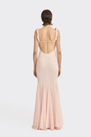 Light pink CULT MIA X Stolen Stores croissant maxi slip dress displayed on a hanger, showcasing its flowing fabric and elegant design.