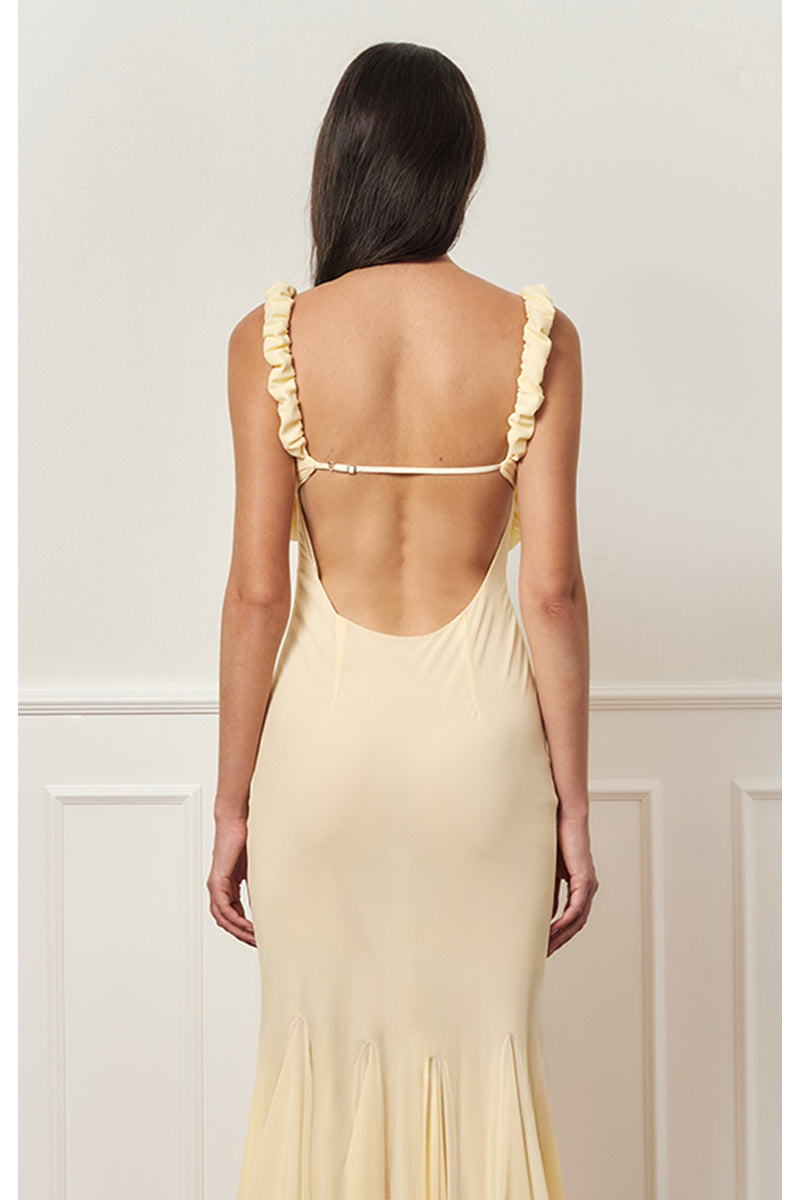 Light yellow maxi slip dress by Stolen Stores featuring a relaxed fit and elegant style, shown on a model.
