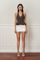Mini dark brown croissant-shaped top with polka dot pattern from Stolen Stores, featuring a stylish, casual design.