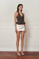 Mini dark brown croissant-shaped top with polka dot pattern from Stolen Stores, featuring a stylish and casual design.