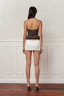 Dark brown mini croissant-shaped top with polka-dot pattern from Stolen Stores, featuring a stylish and fitted design.