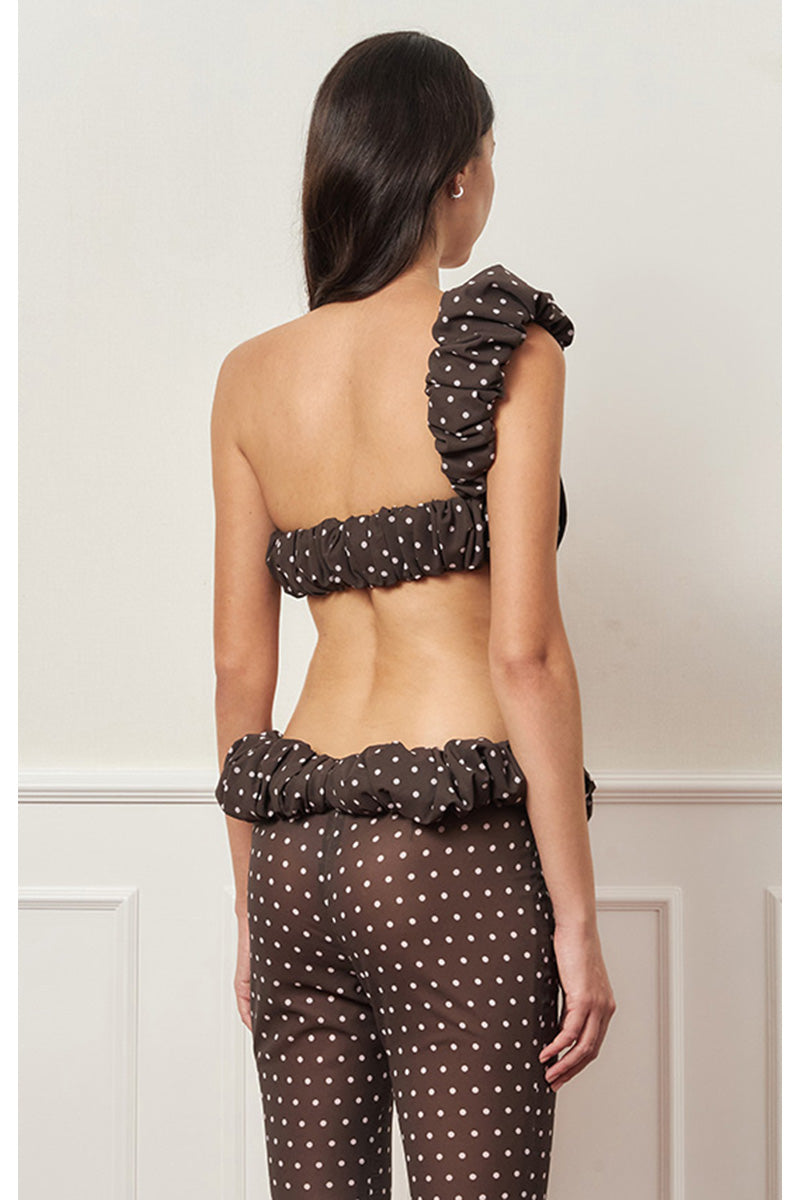 Brown polka dot one-shoulder top from Stolen Stores featuring a stylish croissant neckline and trendy design.