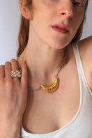 Gold croissant chain necklace by Oz Objects featuring a delicate, detailed croissant pendant on a sleek gold chain.