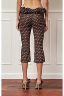Brown polka dot croissant capri pants by Stolen Stores, stylish and comfortable women's pants with a playful pattern.