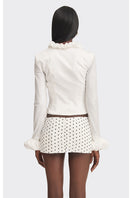 White croissant-shaped corset shirt by Stolen Stores, featuring a fitted top with unique pastry-inspired design.