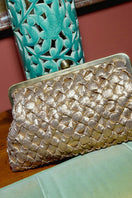 Gold crossed design clutch bag from Sarah's Bag, featuring a sleek and elegant gold-tone finish with a stylish clasp.
