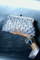 Silver crossed clutch bag by Sarah's Bag featuring a sleek, elegant design with crossed silver accents.