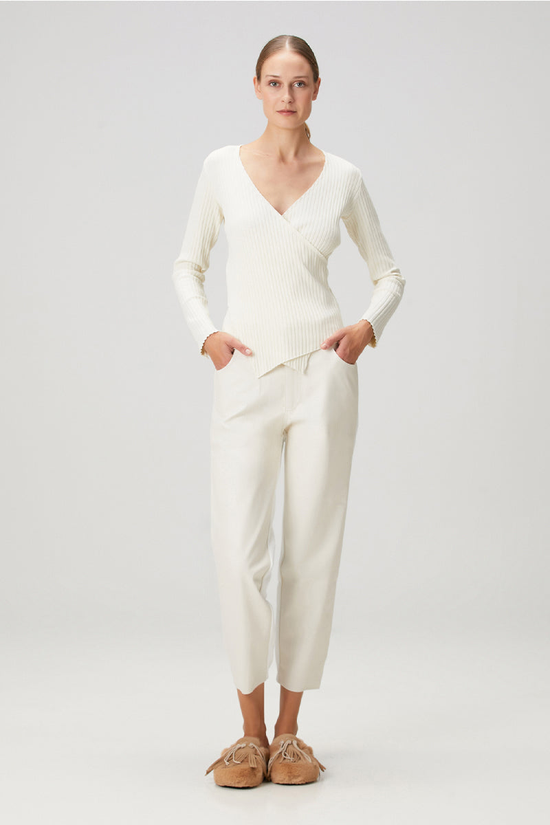 White Bassigue crossover ribbed top, showcasing a stylish, fitted shirt with a crossover design and ribbed fabric texture.