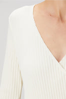 White crossover ribbed shirt by Bassigue, featuring a stylish crossover design and fitted ribbed fabric for a trendy look.