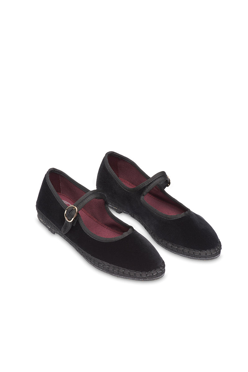 Black Flabelus Antonia flats with pointed toes and sleek design, shown on a model's feet.