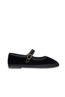 Black Flabelus Antonia flats shown from a side view, featuring a sleek design and comfortable slip-on style.