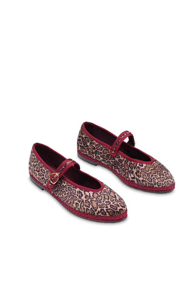 Brown Flabelus Pierre flats shoes with a sleek design, shown on a model's feet.