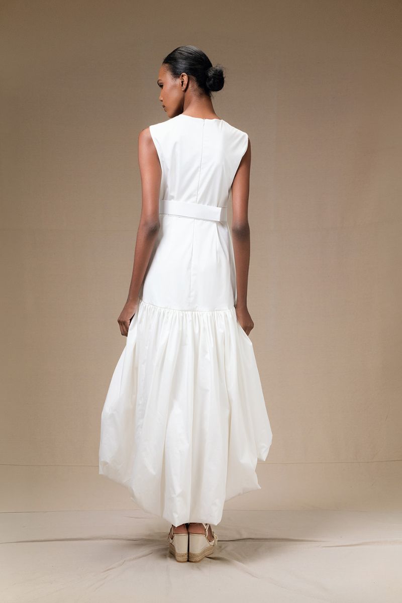 Ivory Cupula Dress by ANA + MARIA, a flowy maxi dress with elegant design, shown on a model in a web photo.
