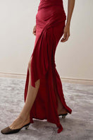 Close-up of YASSMIN SALEH Curve Gown maxi dress in vibrant red fabric, highlighting elegant design details.
