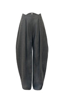 YASSMIN SALEH Curve wool pants in gray, tailored with a sleek fit and soft fabric, shown on a model.