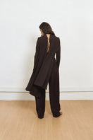 Back view of YASSMIN SALEH brown curve crepe pants showing tailored fit and smooth fabric.