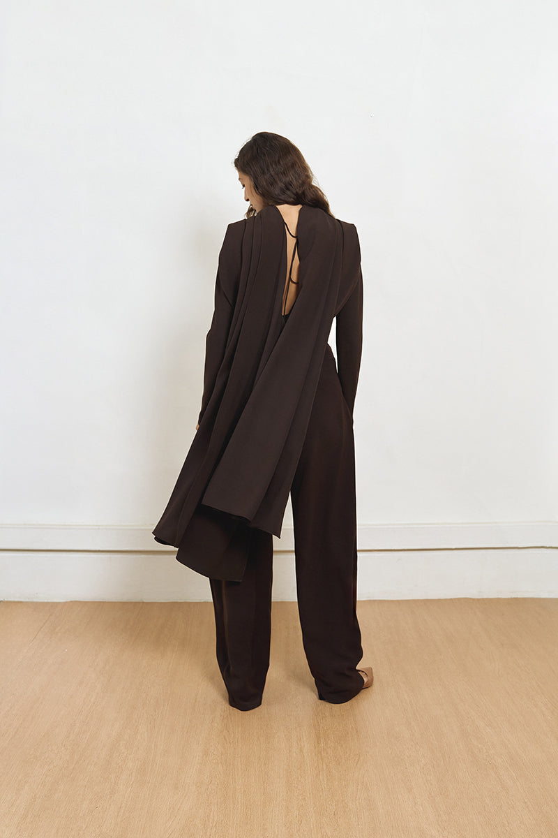 Back view of YASSMIN SALEH brown curve crepe pants showing tailored fit and smooth fabric.