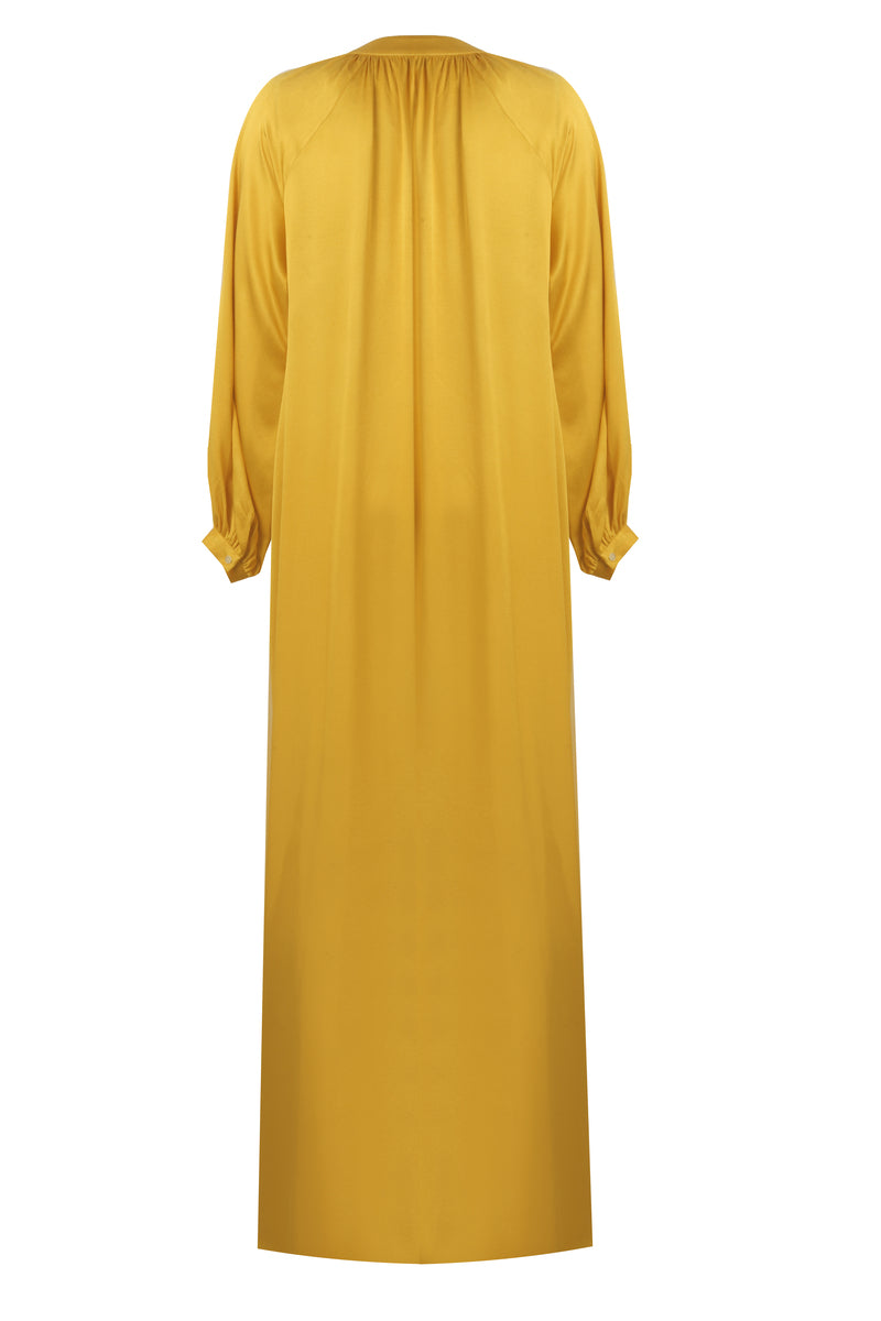 Bocan Couture Nora long saffron nightgown with button details, soft fabric, and relaxed fit, displayed on a hanger.