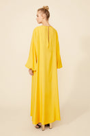 Bocan Couture Nora long buttoned saffron nightgown with flowing fabric and relaxed fit, displayed on a hanger.