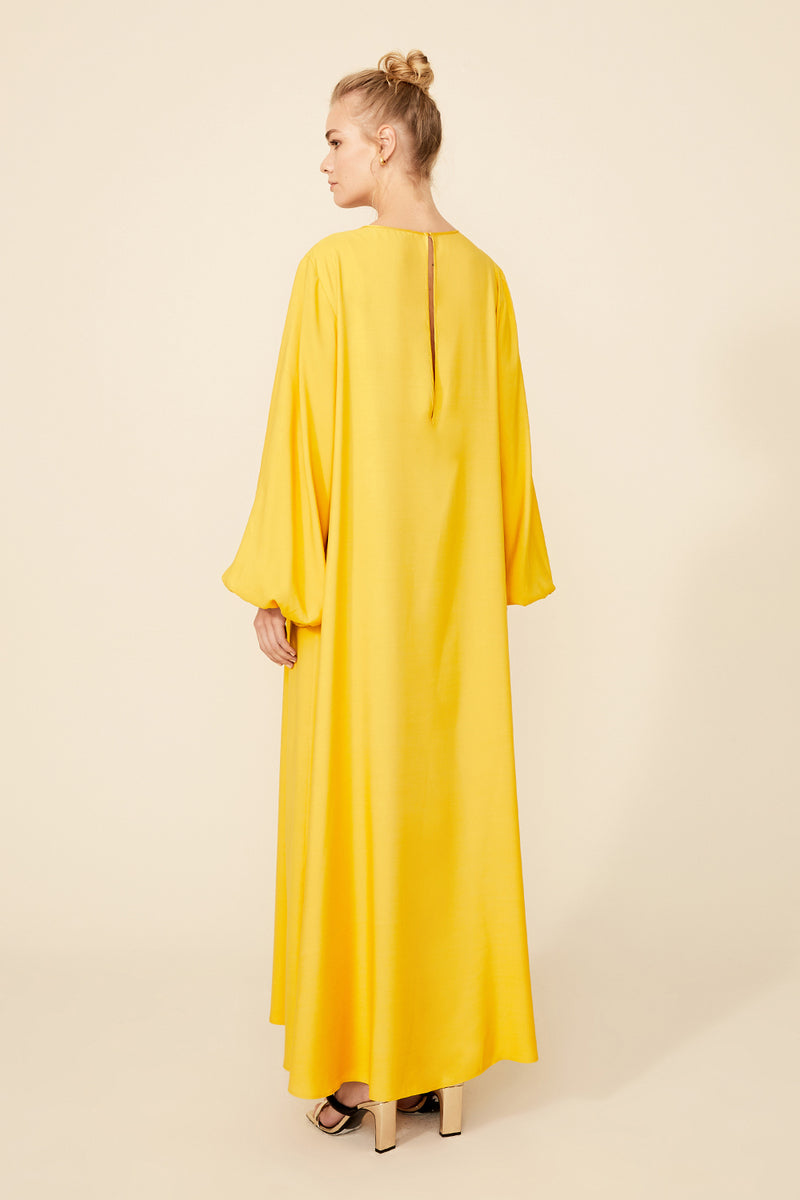 Bocan Couture Nora long buttoned saffron nightgown with flowing fabric and relaxed fit, displayed on a hanger.